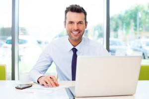 Happy businessman working at the office