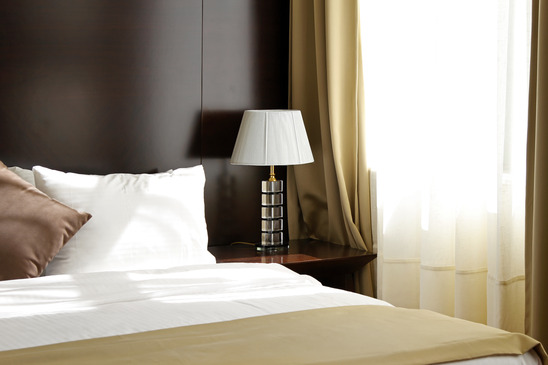 Bed and window in contemporary hotel room